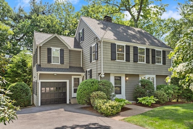 94 Laurel Dr, Needham, MA 02492 - colonial home featuring a shingled roof, asphalt driveway, a chimney, and a garage