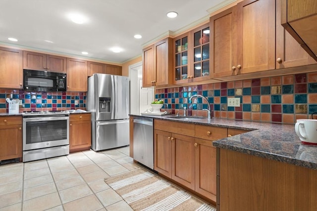 94 Laurel Dr, Needham, MA 02492 - kitchen with stainless steel appliances, brown cabinets, decorative backsplash, and recessed lighting
