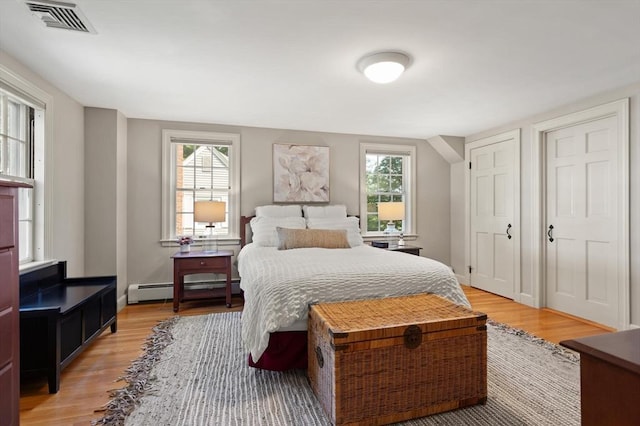94 Laurel Dr, Needham, MA 02492 - bedroom with a baseboard radiator, light wood finished floors, and multiple windows