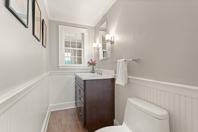94 Laurel Dr, Needham, MA 02492 - half bathroom with a wainscoted wall, vanity, wood finished floors, and ornamental molding