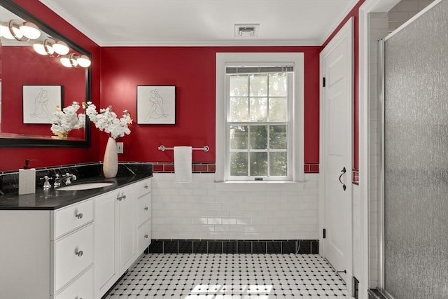 94 Laurel Dr, Needham, MA 02492 - bathroom with vanity, plenty of natural light, a stall shower, crown molding, and tile walls