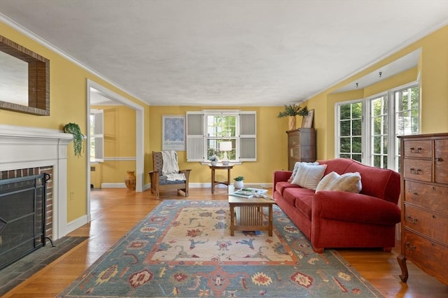 94 Laurel Dr, Needham, MA 02492 - living area featuring a brick fireplace, wood finished floors, and ornamental molding