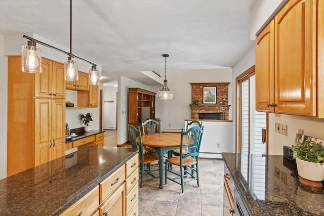 kitchen featuring a baseboard heating unit, a baseboard radiator, and dark stone countertops