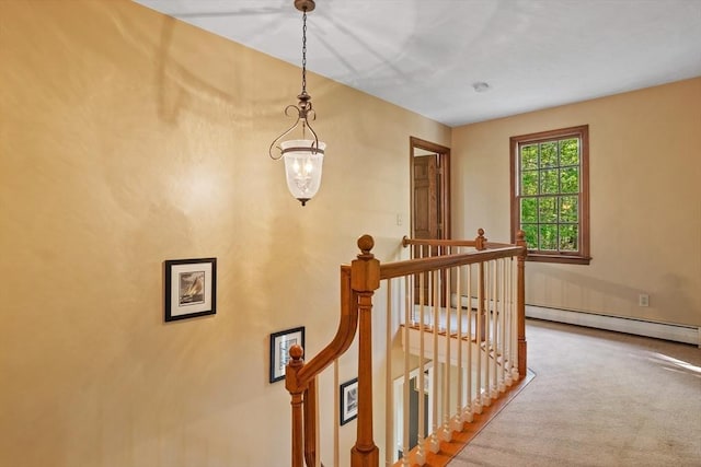 staircase with carpet, baseboard heating, and baseboards
