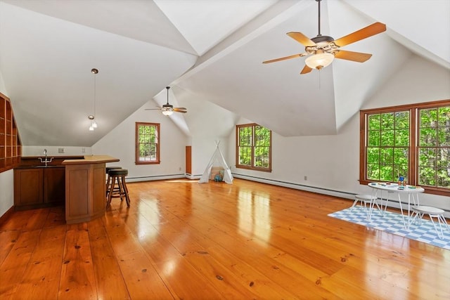 bonus room with ceiling fan, lofted ceiling, healthy amount of natural light, and light wood-style flooring