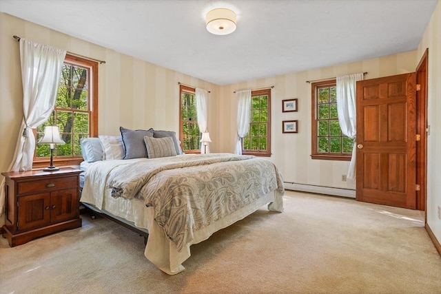 bedroom with baseboard heating, light colored carpet, wallpapered walls, and baseboards