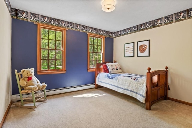 bedroom with a baseboard heating unit, carpet flooring, multiple windows, and baseboards
