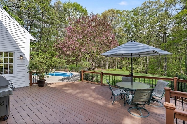 deck featuring outdoor dining space and grilling area