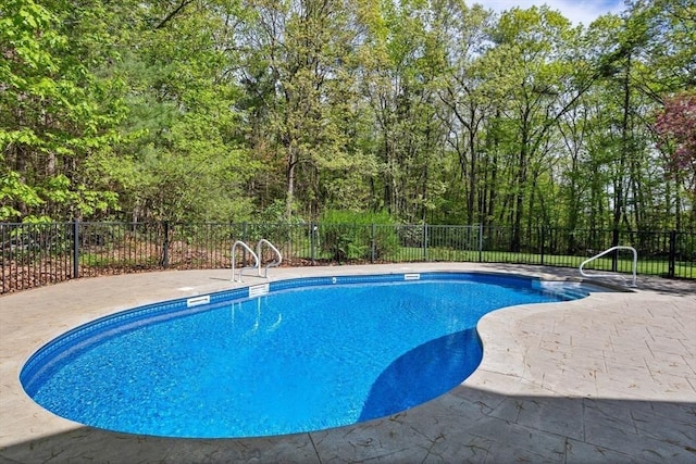 view of swimming pool with fence