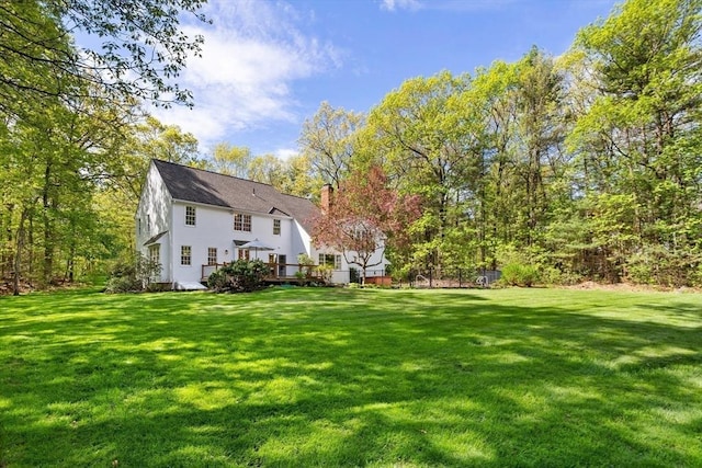 view of grassy yard featuring a deck