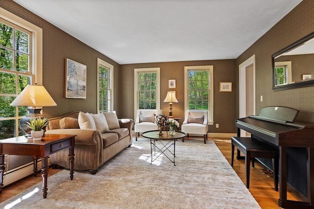 living room with wallpapered walls and wood finished floors