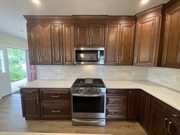 kitchen with stainless steel appliances and backsplash