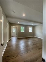 additional living space featuring dark wood-type flooring