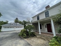 view of home's exterior with a garage and covered porch