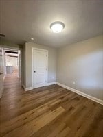 unfurnished bedroom featuring dark hardwood / wood-style flooring