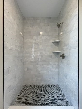 bathroom with tiled shower