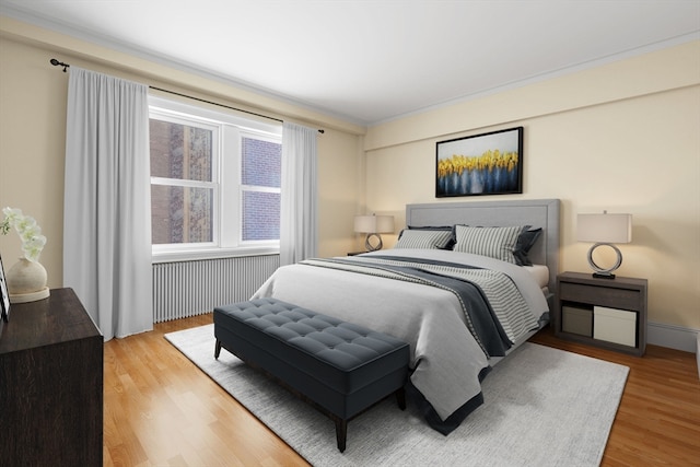 bedroom with radiator heating unit and light wood-type flooring