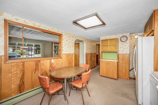 101 Harold Ave, Dracut, MA 01826 - dining room with wallpapered walls, baseboard heating, wainscoting, arched walkways, and light carpet