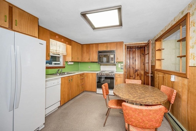 101 Harold Ave, Dracut, MA 01826 - kitchen with white appliances, a baseboard radiator, light countertops, and brown cabinetry