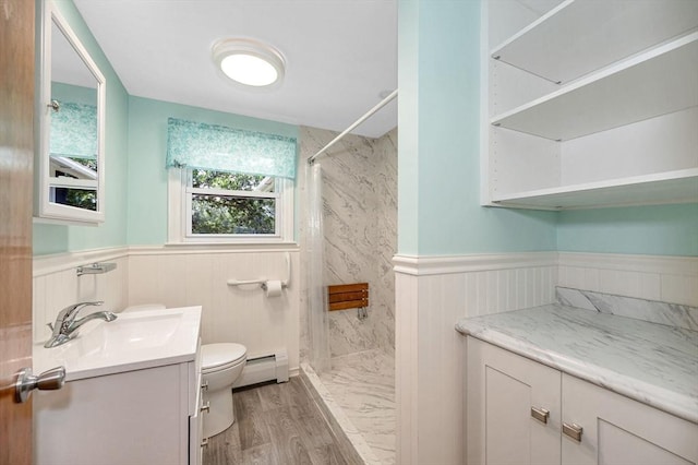 101 Harold Ave, Dracut, MA 01826 - full bath featuring vanity, a wainscoted wall, wood finished floors, baseboard heating, and a shower with curtain