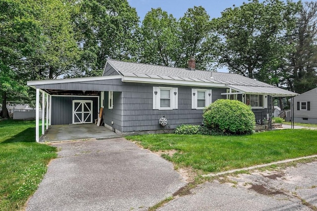 101 Harold Ave, Dracut, MA 01826 - view of front facade featuring an attached carport, a front yard, driveway, and a chimney