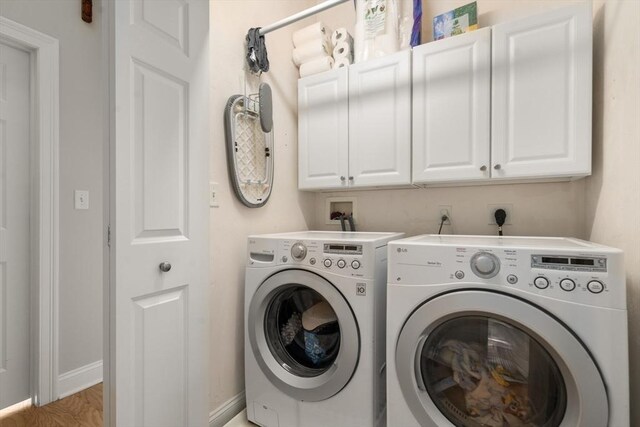 215 Harvard St Unit 40, Medford, MA 02155 - laundry area featuring cabinet space, washing machine and clothes dryer, light wood-style floors, and baseboards