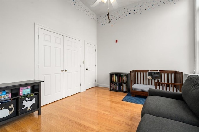 215 Harvard St Unit 40, Medford, MA 02155 - bedroom featuring light wood-style flooring, a high ceiling, a closet, and a ceiling fan