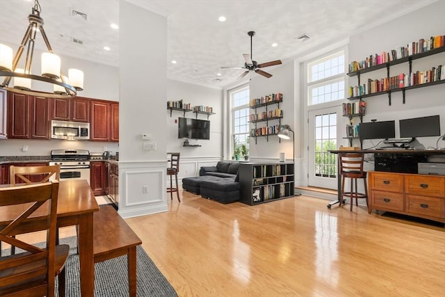 215 Harvard St Unit 40, Medford, MA 02155 - kitchen featuring appliances with stainless steel finishes, light wood-style flooring, ceiling fan, a desk, and open floor plan