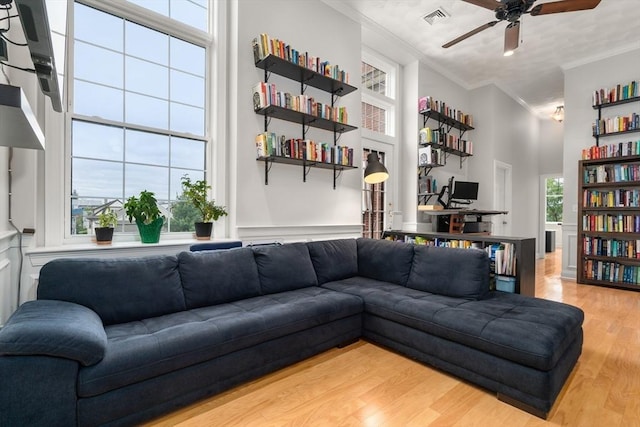 215 Harvard St Unit 40, Medford, MA 02155 - living room with crown molding, ceiling fan, wood finished floors, and a towering ceiling