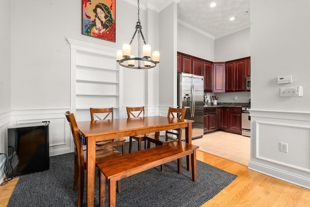 215 Harvard St Unit 40, Medford, MA 02155 - dining area with a chandelier, crown molding, light wood finished floors, built in shelves, and recessed lighting