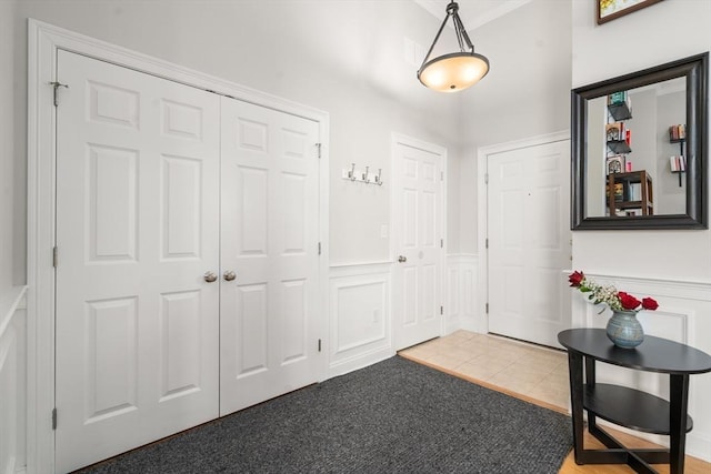 215 Harvard St Unit 40, Medford, MA 02155 - tiled entryway featuring a decorative wall and wainscoting