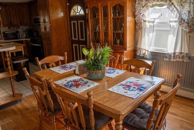 89 Audubon Ave, Braintree, MA 02184 - dining room featuring light wood finished floors and a baseboard heating unit