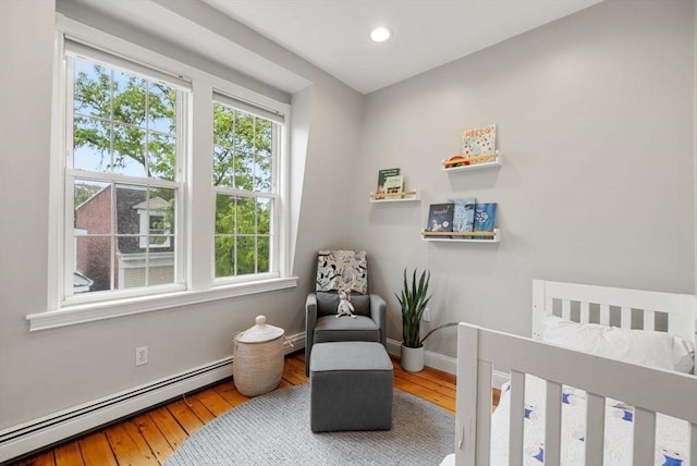 7 Trenton St Unit 2, Boston, MA 02129 - bedroom with baseboard heating, a nursery area, hardwood / wood-style flooring, baseboards, and recessed lighting