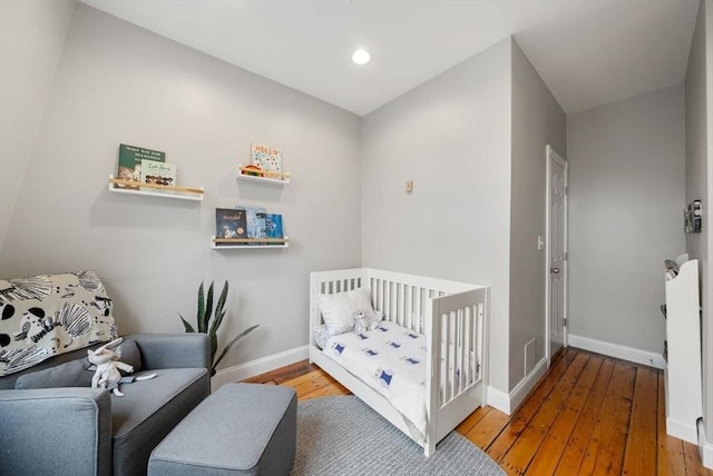 7 Trenton St Unit 2, Boston, MA 02129 - bedroom featuring wood-type flooring, baseboards, a crib, and recessed lighting