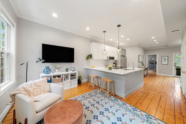 7 Trenton St Unit 2, Boston, MA 02129 - living room featuring light wood-type flooring, recessed lighting, baseboards, and crown molding