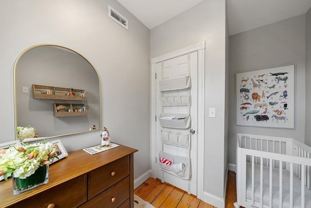 7 Trenton St Unit 2, Boston, MA 02129 - bedroom with light wood finished floors, a nursery area, baseboards, and a desk