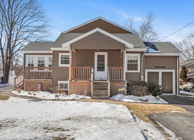 view of front of home featuring covered porch and a garage