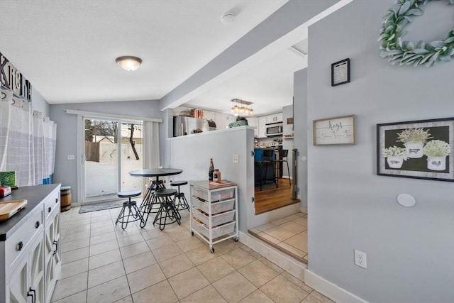 dining area featuring lofted ceiling and light tile patterned flooring