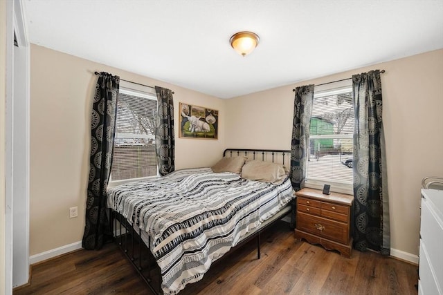 bedroom with dark hardwood / wood-style flooring