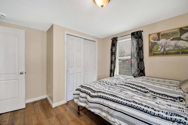 bedroom with hardwood / wood-style flooring and a closet