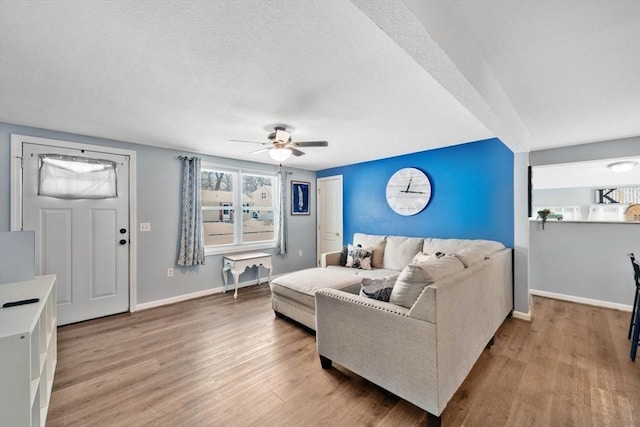 living room with light wood-type flooring and ceiling fan