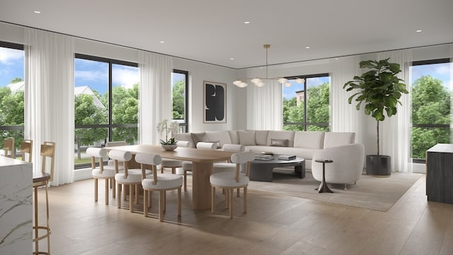 dining room featuring a chandelier, light hardwood / wood-style floors, and a healthy amount of sunlight