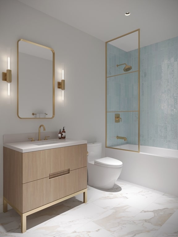 full bathroom with vanity, tiled shower / bath combo, and toilet