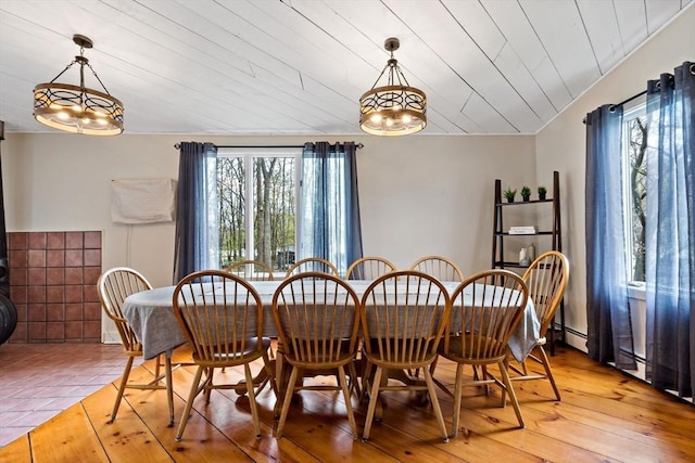 dining area with wood ceiling, a chandelier, light wood-style flooring, and a baseboard radiator