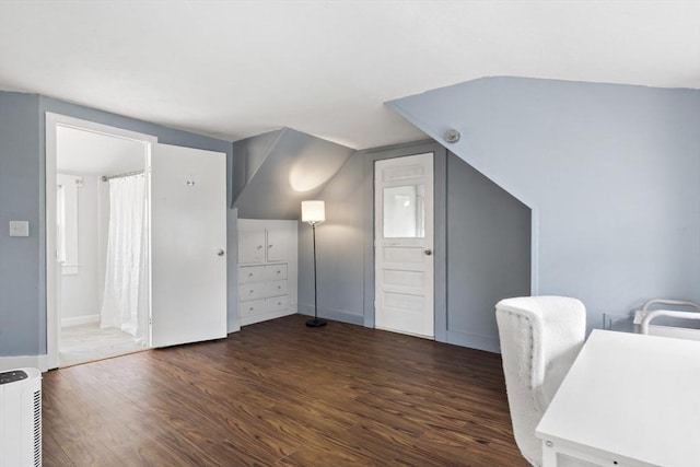 office space with vaulted ceiling and wood finished floors