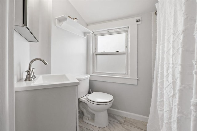 bathroom featuring vanity, toilet, baseboards, curtained shower, and vaulted ceiling