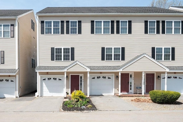 townhome / multi-family property featuring a porch, a garage, and driveway