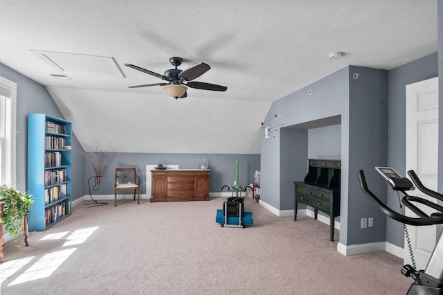 interior space with baseboards, a ceiling fan, carpet floors, and lofted ceiling