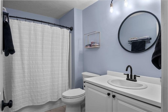bathroom with vanity, tile patterned flooring, and toilet