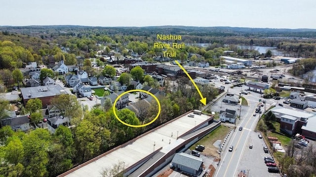 drone / aerial view featuring a wooded view